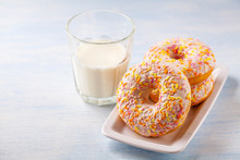 Vanilla Donuts With Milk On A Blue Wooden Background