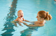 © JenkoAtaman - Mother and baby swim  in pool