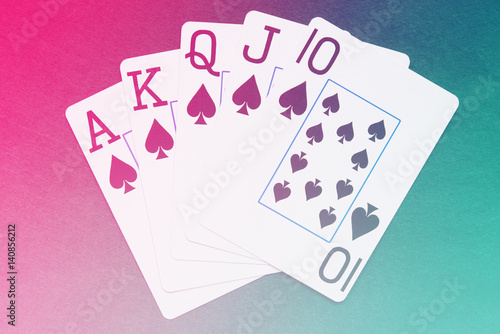 Royal Flush playing cards hand on colorful background плакат