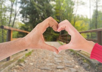 Canvas Print - Close-up of couple showing hand heart gesture