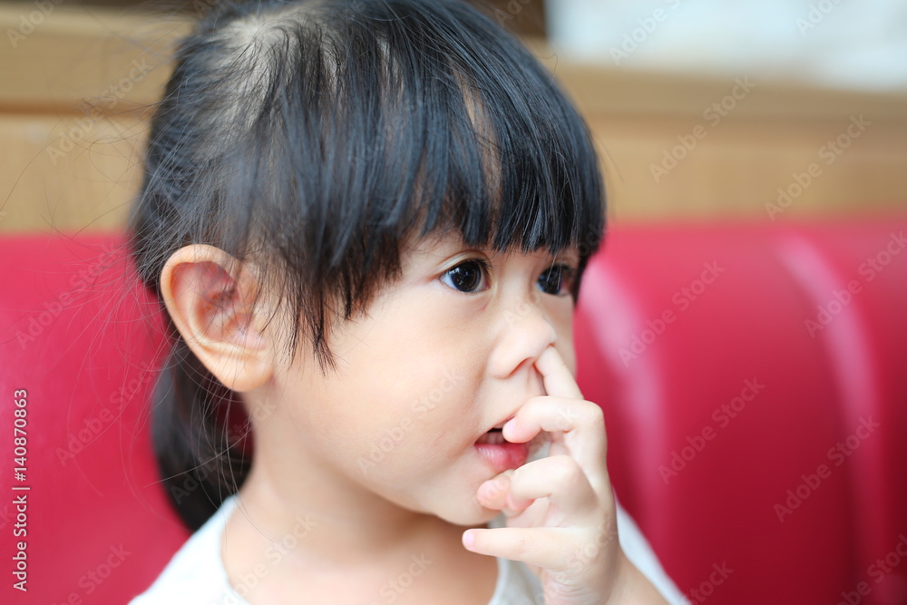 Adorable Asian girl pick her nose Stock Photo | Adobe Stock