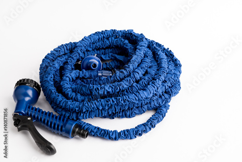 The hose of a garden hose of blue color, made of modern materials, can