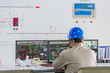 © fanjianhua - workers in control room of a factory.