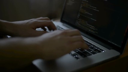 Wall Mural - programmer from behind and programming code on computer monitor programming code is my own property 