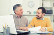 © JackF - Adult man and agent discuss contract