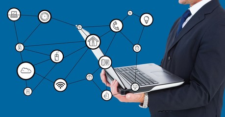 Wall Mural - Businessman holding laptop with connecting icons