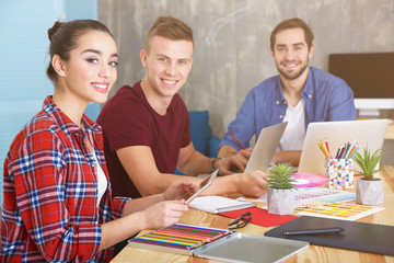 Poster - Three young designers at workplace