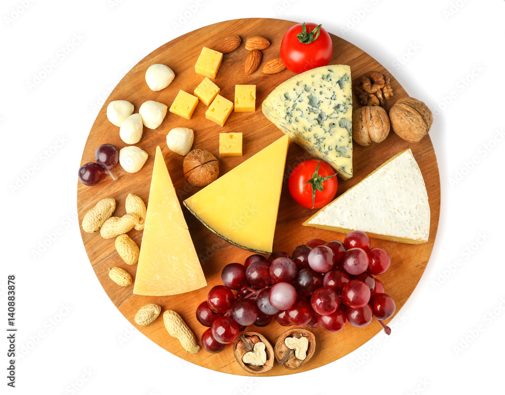 Board with assortment of delicious cheese, tomatoes and nuts on white background