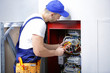 © Africa Studio - Electrician connecting wires in distribution board