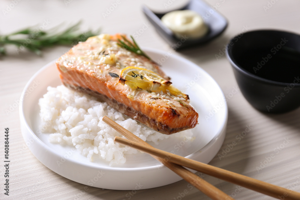 Delicious roasted salmon fillet with rice on white plate