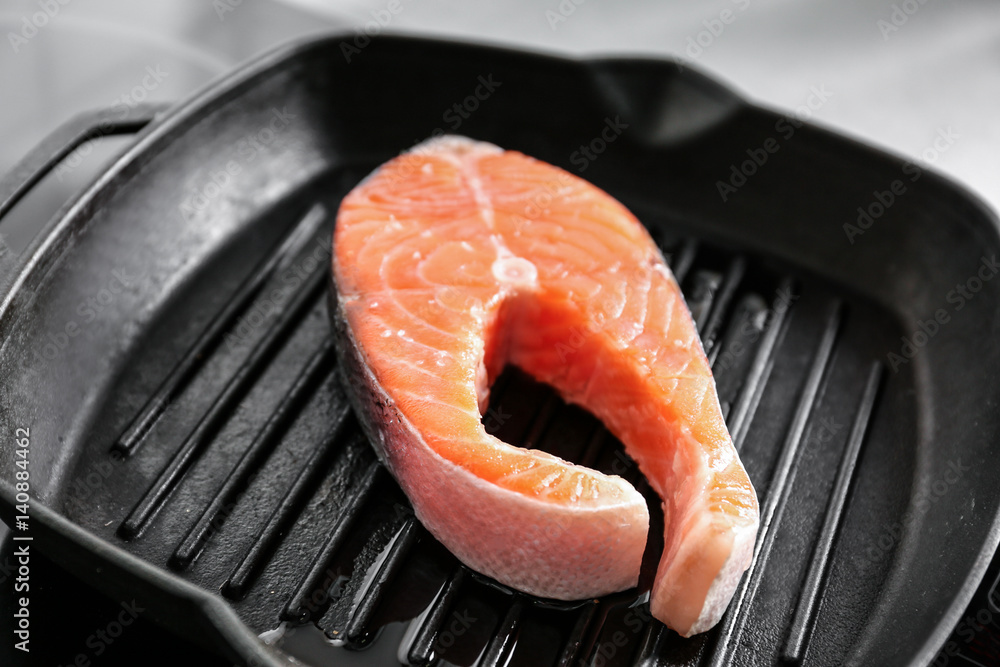 Cooking salmon steak on grill pan