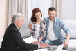 © Africa Studio - Young couple signing contract sitting on couch at home