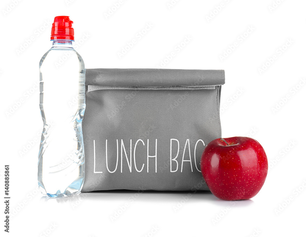 Healthy food concept. Lunch bag for school children with apple and bottle of water on white background