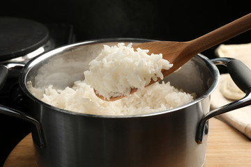 Canvas Print - Cooked rice in metal saucepan, closeup