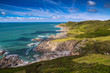 © shpak - Picturesque view of the North coast of Devon. Grunta beach and Mortehoe point in the distance. Striped sky. England