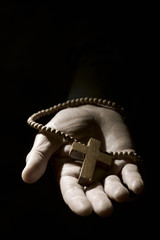 Wall Mural - young man with a rosary in his hand