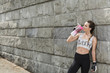 © Photographee.eu - Sporty woman drinking from a watter bottle