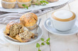 Stracciatella-Bananen-Muffins mit Cappuccino -Freshly baked chocolate banana muffins with a cup of cappuccino