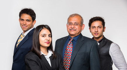 Wall Mural - Group of good looking Indian business people or lawyers. Business team or delegation from India. standing isolated over white background