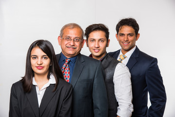 Wall Mural - Group of good looking Indian business people or lawyers. Business team or delegation from India. standing isolated over white background