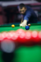 Wall Mural - young man lines up his shot as he breaks the balls for  start  game of billiards