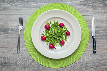 Rocket salad and radishes on a plate