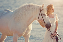 Girl In White Dress With Horse On The Beach