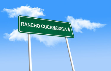 Road sign - Rancho Cucamonga. Green road sign (signpost) on blue sky background. (3D-Illustration)
