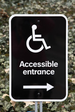 A Black And White Accessible Entrance Sign 