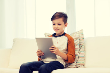 Canvas Print - smiling boy with tablet computer at home