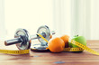 © Syda Productions - close up of dumbbell, fruits and measuring tape