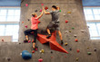 © Syda Productions - man and woman exercising at indoor climbing gym
