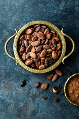 Canvas Print - Cocoa beans and powder on dark background, top view, copy space, flat lay