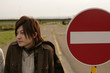 Young man and road sign