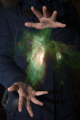 Wall Mural - The vast universe in the hands of a child. Elements of this image furnished by NASA.