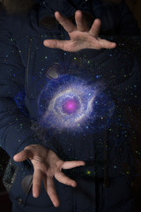 Wall Mural - The vast universe in the hands of a child. Elements of this image furnished by NASA.