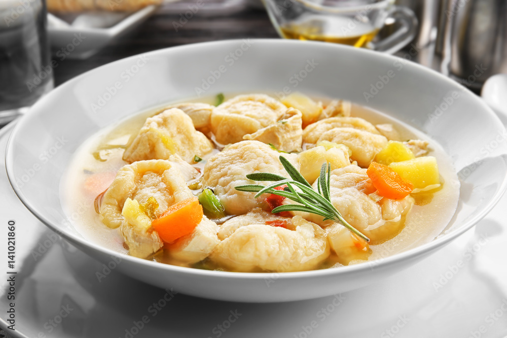 White plate of delicious chicken and dumplings closeup