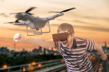 Man with 3D virtual reality glasses is controlling a flying drone.