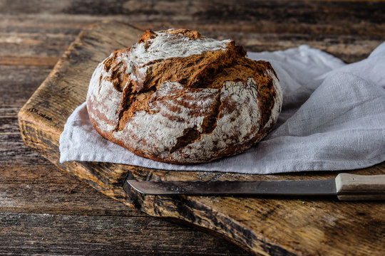 Frisches rundes Brot auf einem Holzbrett