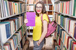 © rh2010 - Young happy and enthusiastic female student searching books on the shelves at the library