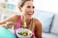 Young Woman Eating Healthy Salad After Workout