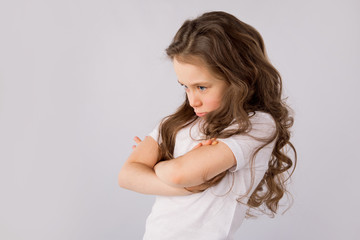 Portrait of angry and sad little girl isolated on white background