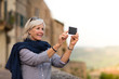© ReeldealHD images - Senior woman on vacation taking a photo