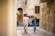 © ReeldealHD images - Young couple walking down street on vacation