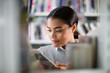 © ReeldealHD images - Student reading a book in library