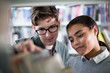© ReeldealHD images - Students looking for a book in library