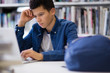 © ReeldealHD images - Student working on laptop in library