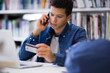 © ReeldealHD images - Student on phone with credit card