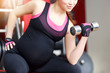 © 4frame group - Pregnant woman exercising in the gym
