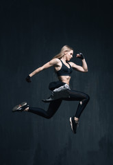 Young beautiful fitness female posing in studio